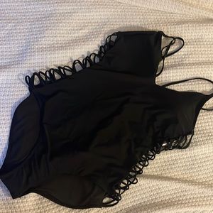 Black one piece with cut out sides… never worn, too big.